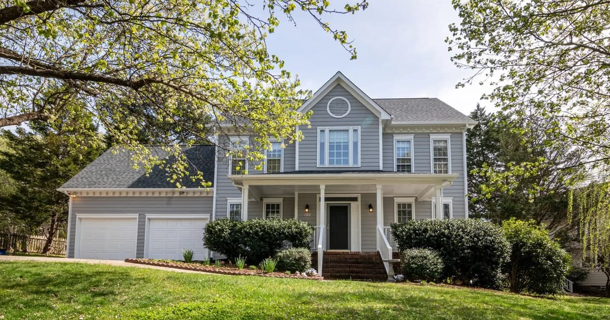 Suburban house with a front lawn and trees in a residential neighborhood