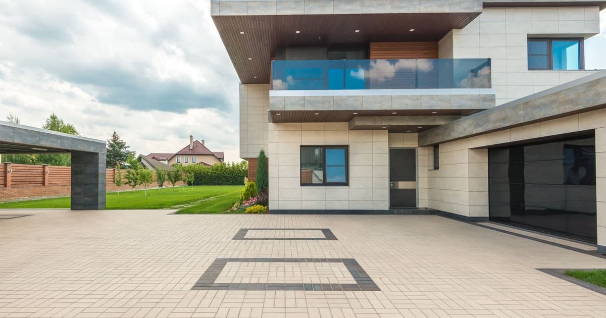 Modern house exterior with a paved driveway and lawn, the kind of finished home a Lahore buyer should inspect before paying