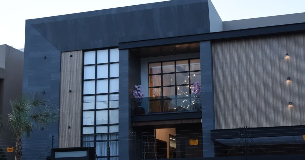 Modern house facade with glass and wood detailing in a Lahore residential area