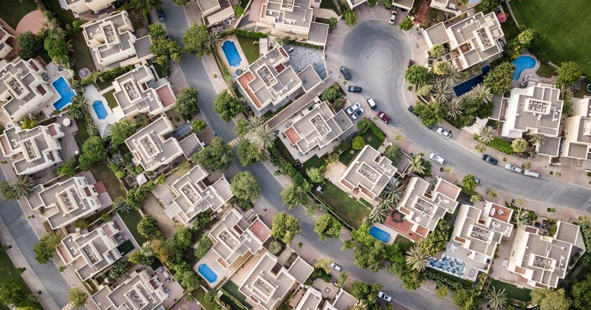 Aerial view of a villa community with swimming pools