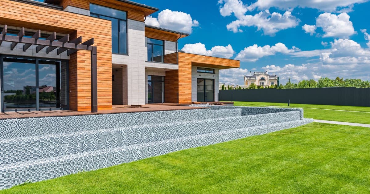 Modern house exterior with landscaped green lawn in Lahore