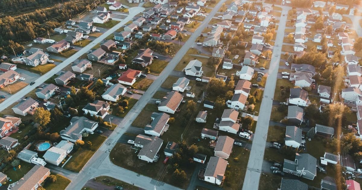 Aerial view of a suburban housing grid with plots, houses and streets
