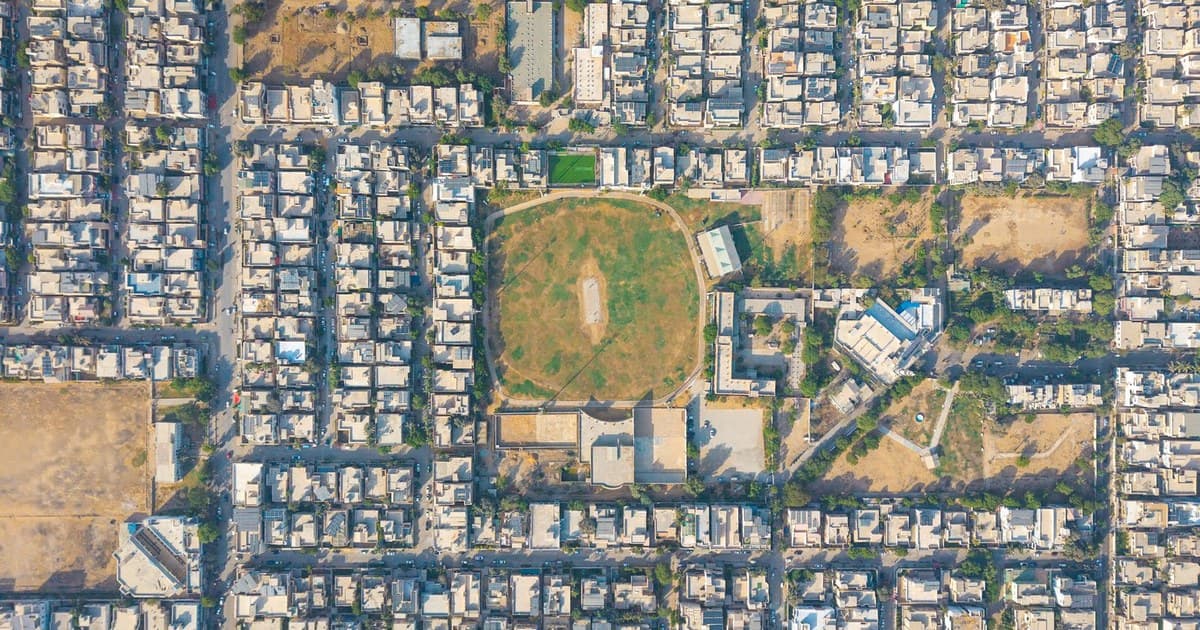 Aerial view of a planned Pakistani residential neighborhood with grid streets and a central park