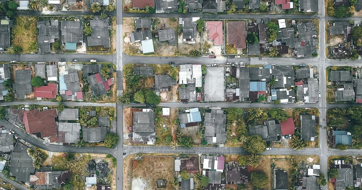 Aerial view of a planned housing society with grid streets and residential plots