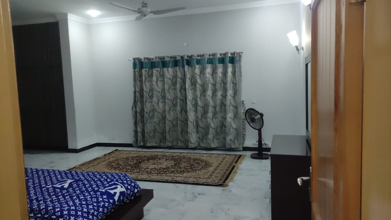 Bedroom with attached washroom and marble flooring