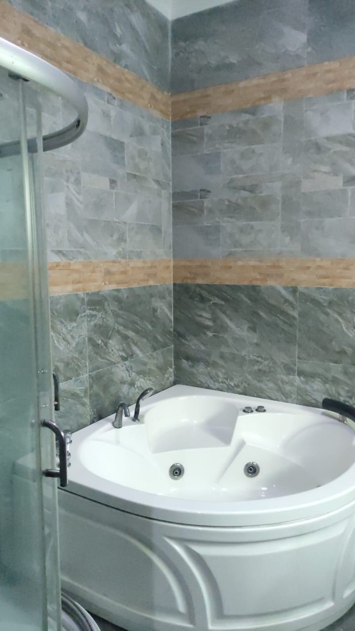 Bathroom with corner jacuzzi tub